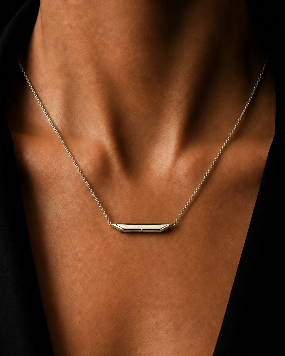 The same necklace in gold, worn on the chest