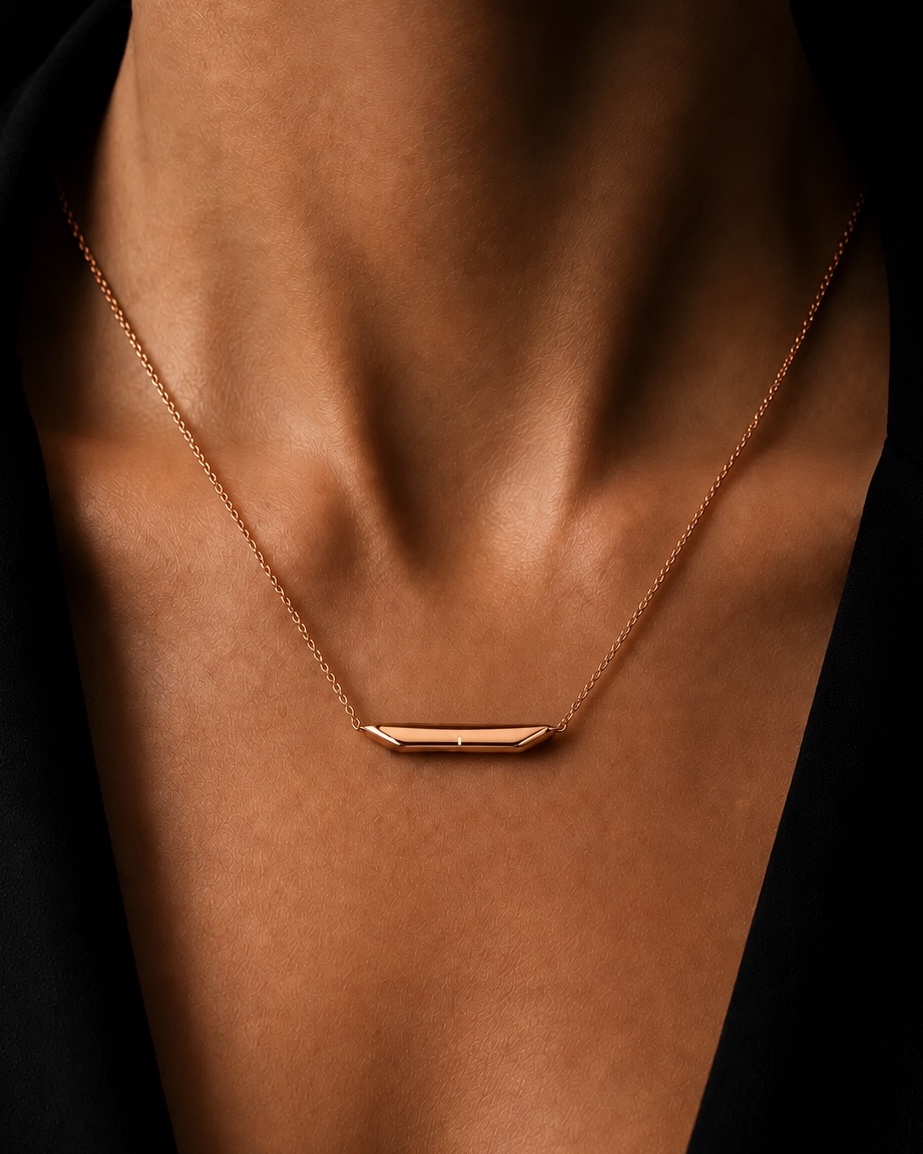 The same necklace in rose gold, worn on the chest